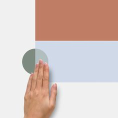 a person's hand is touching the corner of a piece of paper with an oval on it