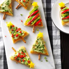 christmas tree appetizers on toasted bread with veggies and sauces