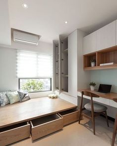 a room with a desk and shelves in it