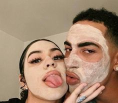 a man and woman with facial masks on their faces