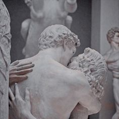 two statues are hugging each other in black and white