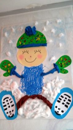 a child's drawing made out of frosting on a sheet of paper with blue and green accents