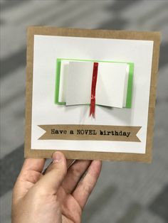 someone is holding up a card with two books on it that says have a novel birthday