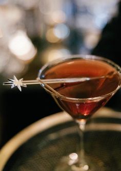 a close up of a drink in a glass on a table