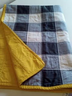 a yellow and black blanket laying on top of a table