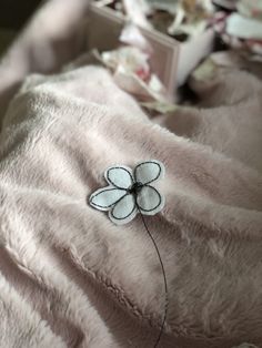 a close up of a flower on a blanket