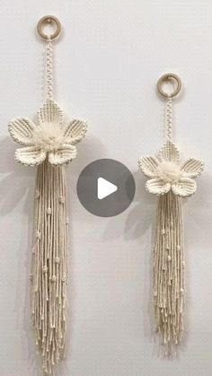 two tassels hanging from hooks on a wall