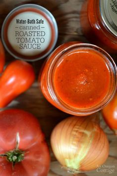 tomatoes, onions and jars of tomato sauce sit on a table next to each other