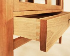 a close up view of a wooden table with drawers