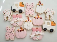 decorated cookies are arranged on a white surface