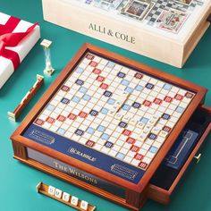 a scrabble board game sitting on top of a table next to a box