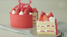 two pieces of cake with strawberries on the top and one slice cut in half