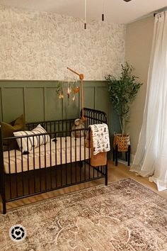 a baby crib in the corner of a room with a rug on the floor