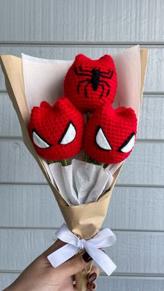 two crocheted spiderman roses in a bouquet