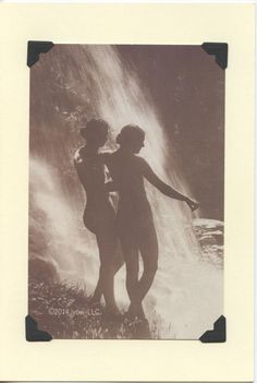 an old photo of two women standing in front of a waterfall with their arms outstretched