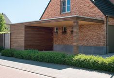 a brick house with two garages on the side