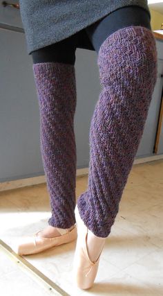 a woman's legs with purple socks and ballet shoes