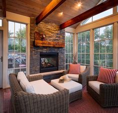 a living room filled with furniture and a fire place in the middle of a room