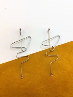 Minimalist Metal Pierced Wrap Earrings, Minimalist Handmade Metal Linear Earrings, Minimalist Metal Wrap Earrings, Modern Wire Wrapped Earrings, Modern Wire Wrapped Drop Earrings, Minimalist Metal Wrap Earrings Gift, Modern Wrap Dangle Earrings, Modern Handmade Dangle Wrap Earrings, Nickel Free Modern Dangle Wrap Earrings