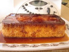 a piece of cake sitting on top of a white plate covered in caramel sauce