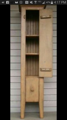 an old wooden cabinet sitting in front of a house