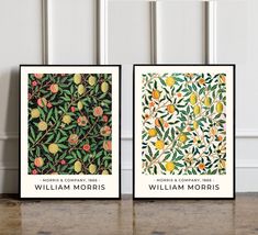 two framed art prints with fruit and leaves on them, one is green and the other is orange