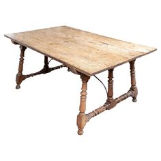 an old wooden table with turned legs and no leaves on the top, isolated against a white background