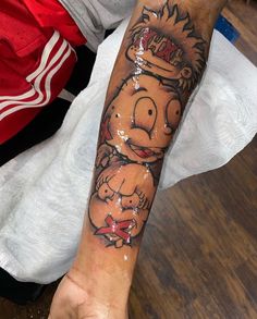 a man's arm with a cartoon character on it