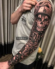 a man with a full sleeve tattoo on his arm