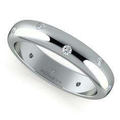 a white gold wedding ring with three diamonds