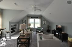 a living room filled with furniture and a flat screen tv