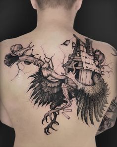 the back of a man's chest with an eagle and birdhouse tattoo on it