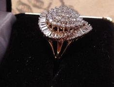 "This ring is gorgeous! It is from an Estate in New York City. The owner was an actress in the New York Theatre, and loved large diamond rings. This definitely fits the bill! It is a \"Ballerina\" design ring. The description of a Ballerina ring is \"fanciful and a distinctive style of gems\" in this case Diamonds! The cluster of Diamonds in the center simulates the flowing movement of a Ballerina dancing, and creates a swirling effect of Diamonds on the finger. Baguettes are usually used in thi Anniversary Cluster Ring With Brilliant Cut, Marquise Cut Rings With Vvs Clarity For Proposal, Anniversary Cluster Diamond Ring With Center Stone, Yellow Gold Cluster Diamond Ring For Anniversary, Yellow Gold Diamond Cluster Ring For Anniversary, Dazzling Emerald Cut Cluster Ring For Anniversary, Cluster Diamond Cut Ring For Anniversary, Anniversary Yellow Gold Cluster Diamond Ring, Pear-shaped Diamond Cut Cluster Ring For Wedding