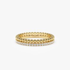 three rows of yellow gold and white diamond rings on a white background with space for text