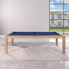 a pool table in front of a large window