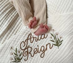 a baby's feet on top of a white blanket with the words area region written in it