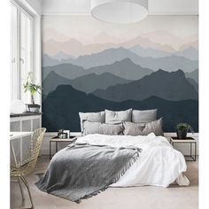 a bedroom with mountains painted on the wall