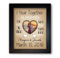 a framed photo with the words, i year together and two hearts in black frame