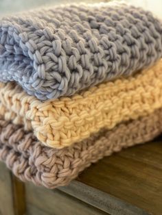 three crocheted blankets stacked on top of each other