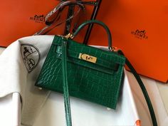 Description HRMS Mini Kelly 19 Green Crocodile Bag For Women, Handbags, Shoulder Bags 7.5in/19cm Rep 1:1 19 x 11.5 x 5.5 cm / 7.5 x 4.5 x 2.2 inches (Length x Height x Width) Medium compartment Gold-toned hardware Interior with 1 side zippered pocket A protective footed bottom Adjustable shoulder strap – Includes box, dust bag. – This product is of the best quality. – The production time is 15-20 working days. – If you want to custom your own bag, please contact us via our fanpage. Mini Kelly, Louis Vuitton Shirt, Green Crocodile, Fendi Peekaboo, Crocodile Bags, Togo Leather, Luxury Products, Mini Crossbody Bag, Evening Clutch Bag