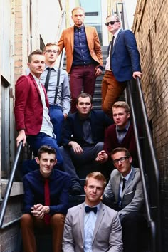 a group of men in suits and ties sitting on stairs