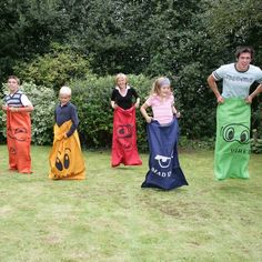 a group of people standing on top of a grass covered field next to each other