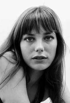 a black and white photo of a woman with long hair