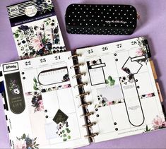 an open planner book sitting on top of a purple table