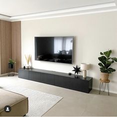 a flat screen tv mounted on the wall in a living room