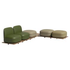 a green and beige couch sitting on top of a wooden table