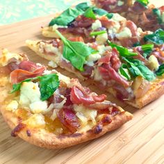 two slices of pizza sitting on top of a wooden cutting board