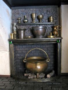 an old fireplace with pots and pans on it