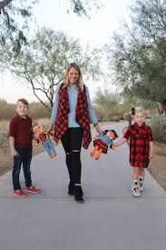 a woman and two children are holding skateboards