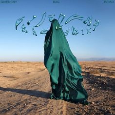 a green cloth covered in water on top of a dirt road next to a blue sky